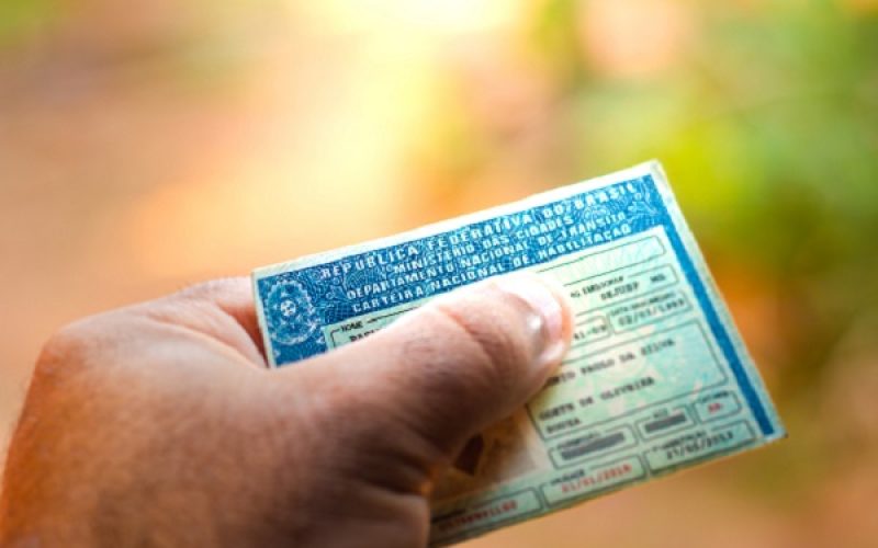 August 28, 2019, Brazil. Man holding document "Carteira Nacional de Habilitação" (CNH). A driver's license attests to a citizen's ability to drive land motor vehicles.